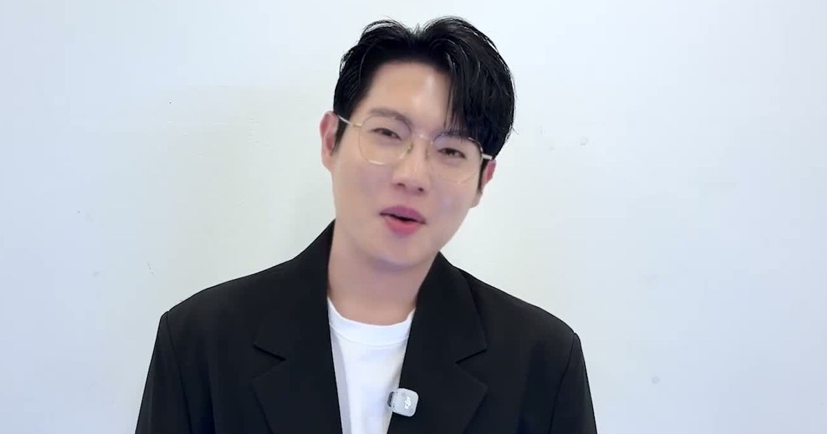 손태진이 안경을 쓰고 검정 재킷 차림으로 환하게 웃으며 말하는 상반신 모습